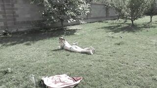 MILF with big natural boobs masturbates her hairy pussy in the garden to orgasm.
