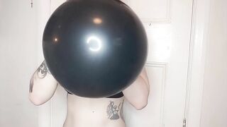 Blowing up large shiny balloon