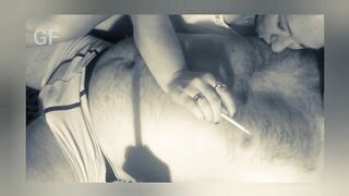 He smokes a cigarette and licks his lover's nipples