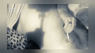 He smokes a cigarette and licks his lover's nipples